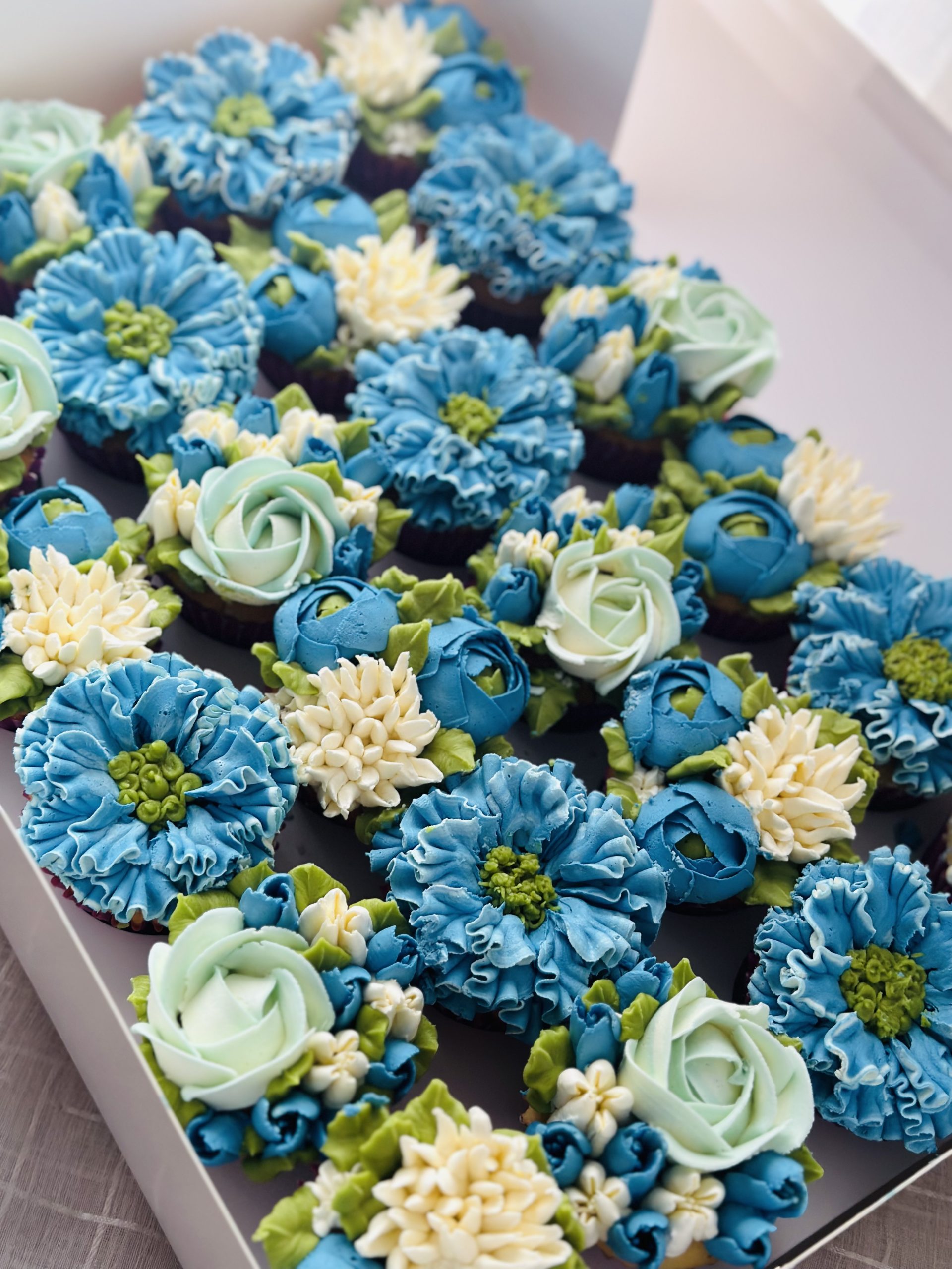 Blue floral cupcake box with flower cupcakes—perfect for birthdays, weddings, and gifts. Order cupcakes online from Floral Cakery, Melbourne